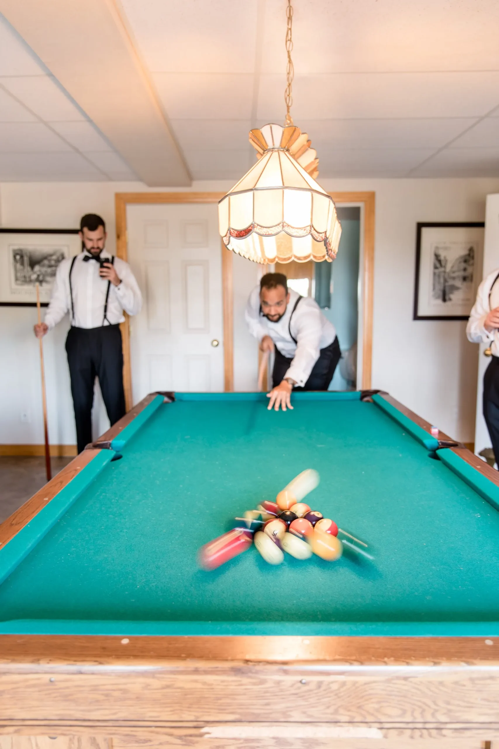Groomsmen having fun in the Billiard Room of the Estate